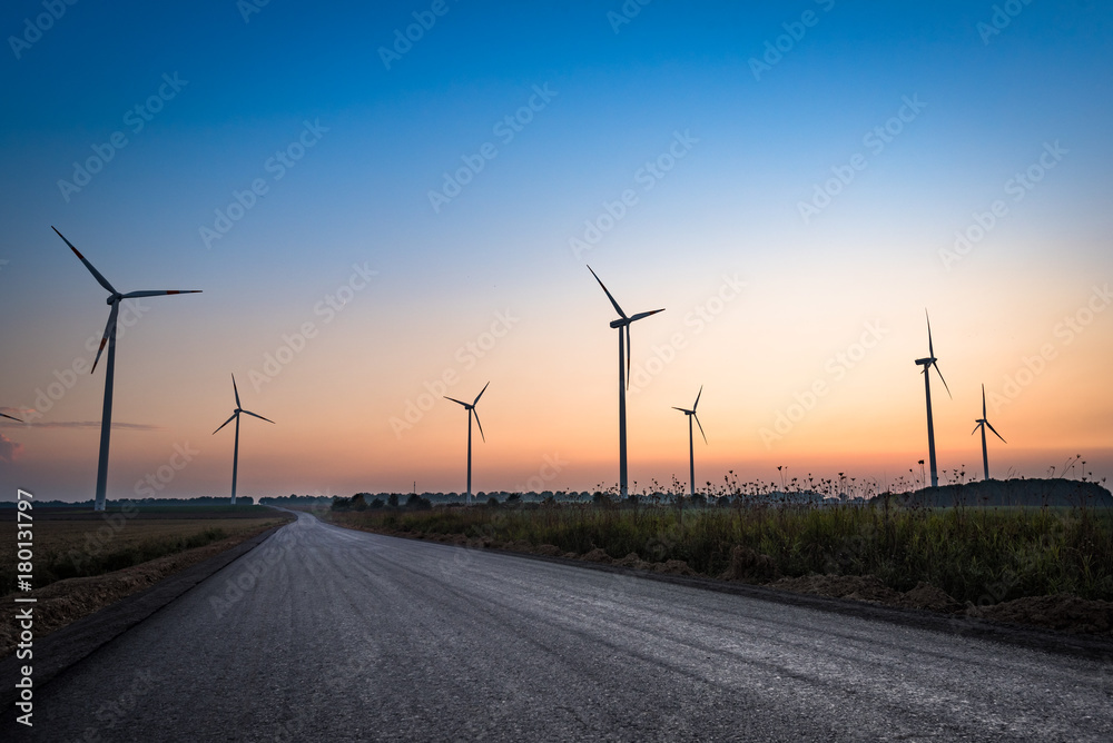 Obraz premium Beautiful silhouette of multiple wind turbines at sunset. Depiction of innovative and sustainable energy and the fight against climate change in Europe. Bedburg, Germany.