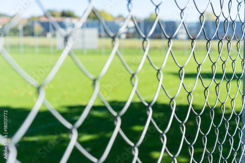 football field seen through iron fence
