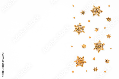 Golden christmas snowflake on white background, flat lay, top view, christmas pattern
