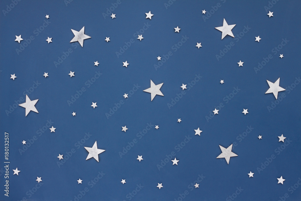 Christmas silver stars on dark blue background. Stars sky, flat lay, top view Christmas silver stars on dark blue background. Stars sky, flat lay, top view