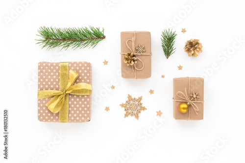 Christmas gift, golden christmas decorations, pine branches on white background, flat lay, top view.