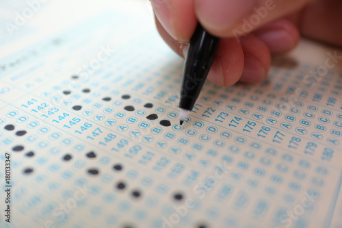 Hand on pencil choosing the test list on the examination