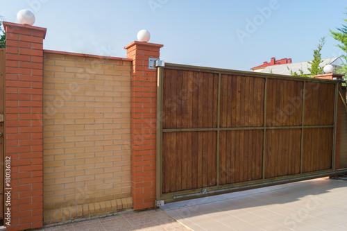 Brown automatic wooden gates of private house. Inside view