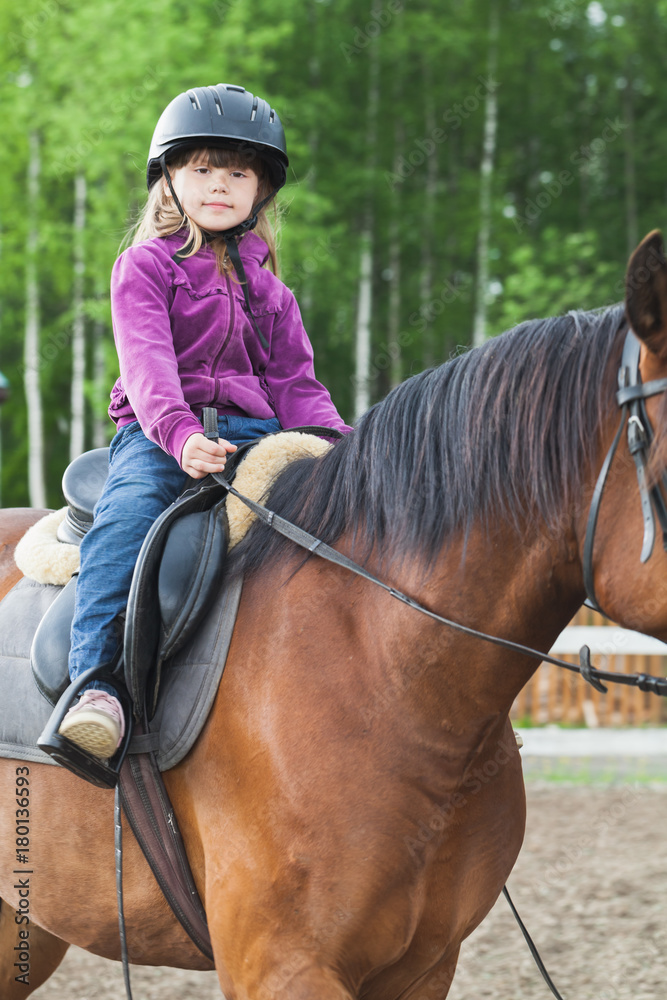Little Caucasian girl is riding a horse Little Caucasian girl is riding a horse