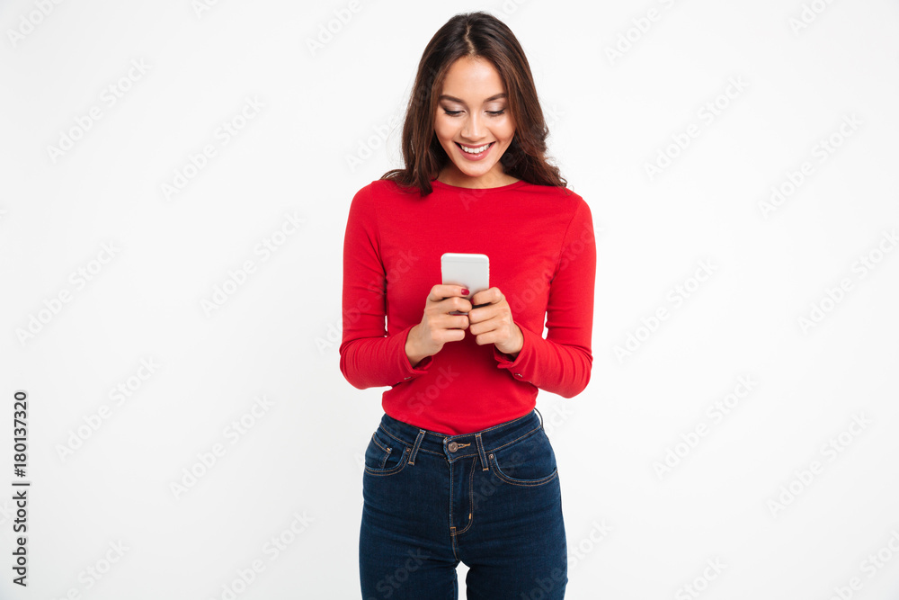 Portrait of a happy satisfied asian woman texting Portrait of a happy satisfied asian woman texting