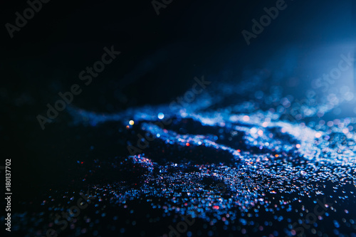 dark and blue abstract glitter background. Blizzard on cold planet surface concept