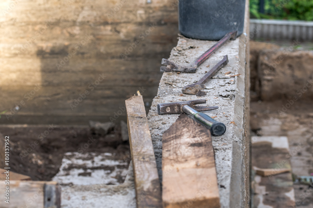 Worker with a crowbar when stripping a wood-clad concrete wall Worker with a crowbar when stripping a wood-clad concrete wall