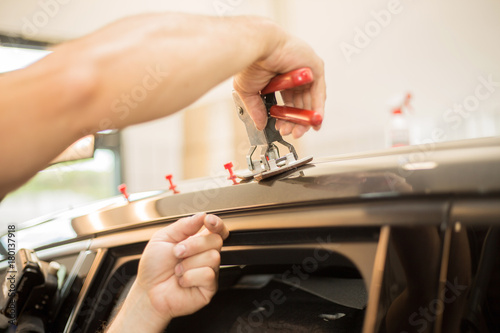 Repairing dents in a car