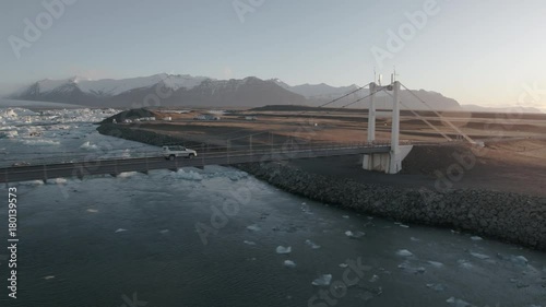 Aerial view of Icelandic bridge with Jökulsárlón Glacier in background - Sunshine light