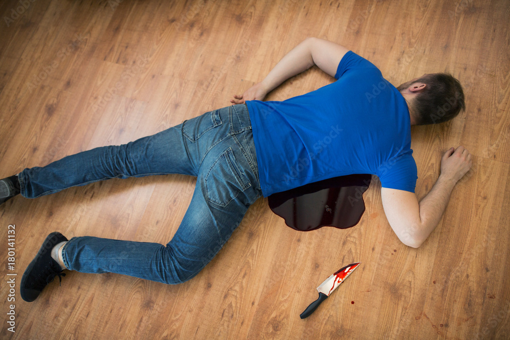 dead man body lying on floor at crime scene Photos | Adobe Stock