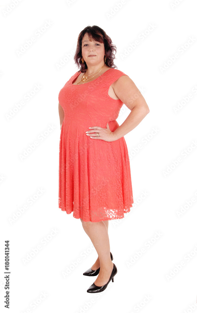 A plus size woman standing in a dress A plus size woman standing in a dress