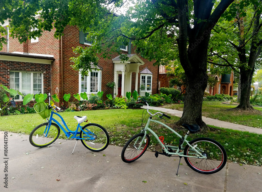 Two Bicycles In Driveway of Brick House