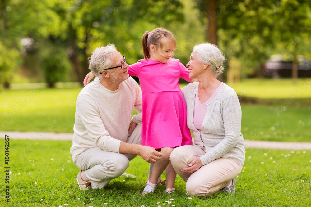 Fototapeta premium senior grandparents and granddaughter at park