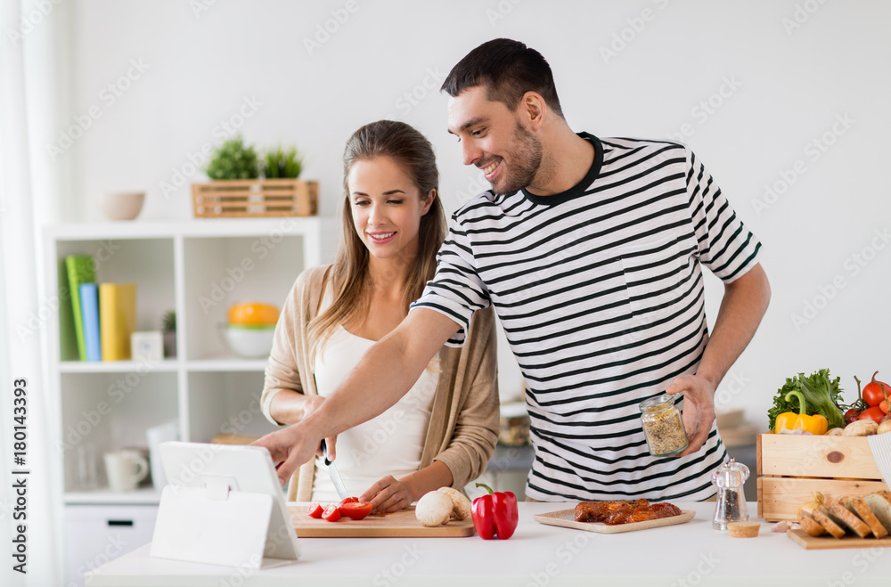 happy couple with tablet pc cooking food at home happy couple with tablet pc cooking food at home