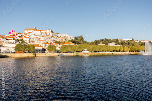 Cityscape view on the old town of Coimbra city with Mondego river during the sunny day in the central Portugal