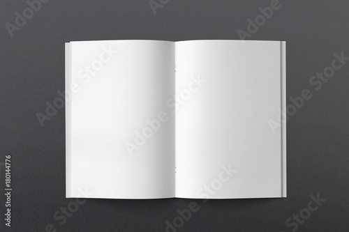 Opened Magazine or Brochure on black paper. Blank pages top view. Mockup template for your showcase.
