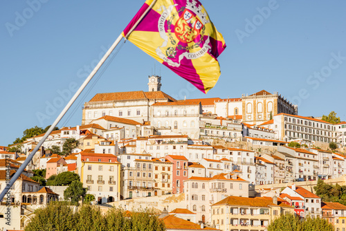Cityscape view on the hill of the old town of Coimbra city with flag in the central Portugal