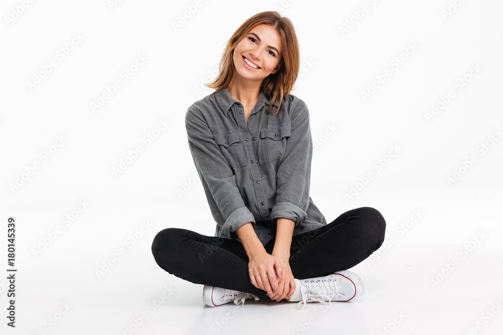 Portrait of a smiling girl sitting and looking at camera Portrait of a smiling girl sitting and looking at camera