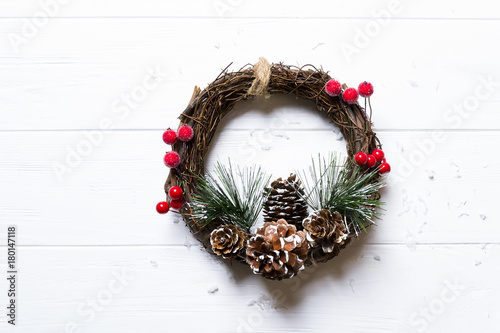 A natural twig wreath on white wooden background photo