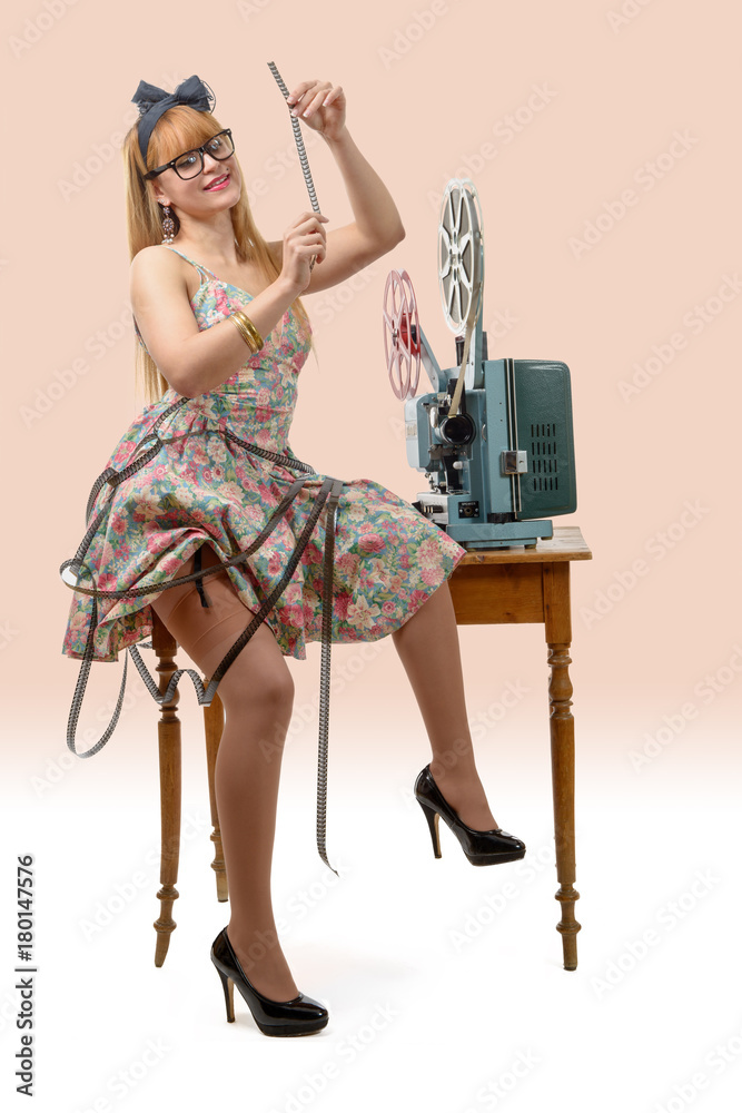 sexy pin-up girl with a film reel and vintage film projector Stock Photo