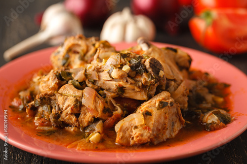 Chicken stew with vegetables and spices - chakhokhbili close-up on the table photo