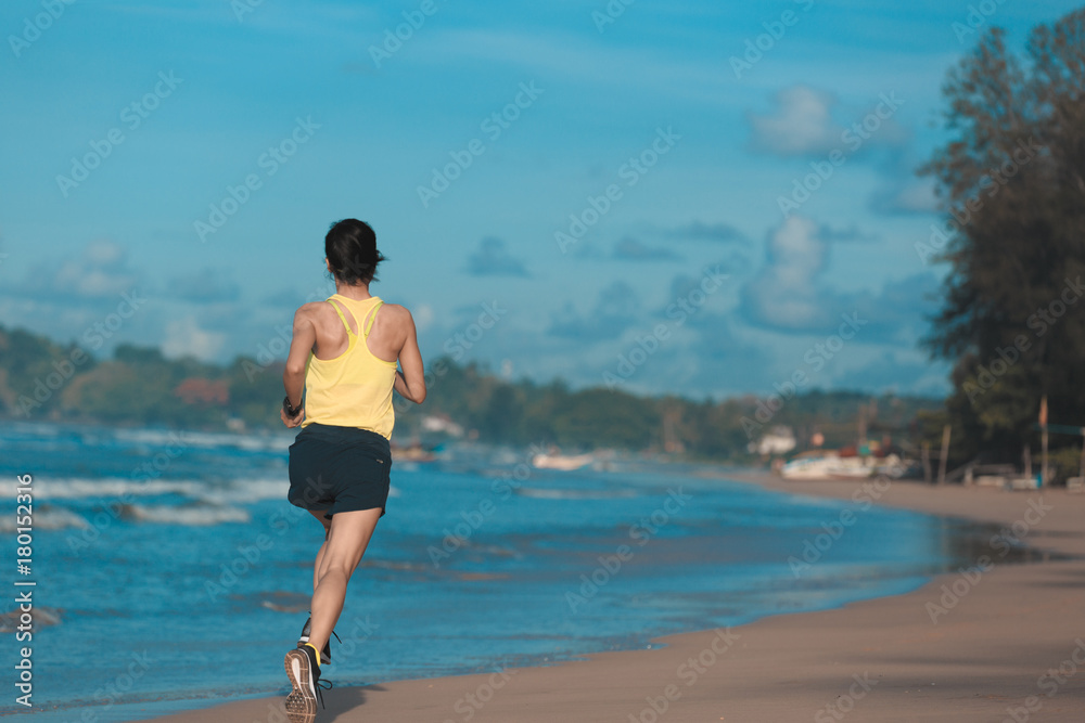 young fitness woman runner running on sandy beach young fitness woman runner running on sandy beach
