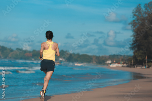 young fitness woman runner running on sandy beach © lzf