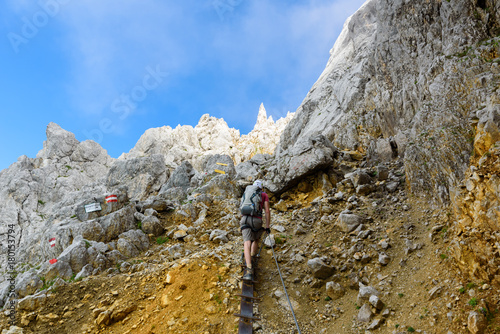 Hiker at Ellmauer Halt, Wilder Kaiser mountains of Austria - close to Gruttenhuette, Going, Tyrol, Austria - Hiking in the Alps of Europe photo
