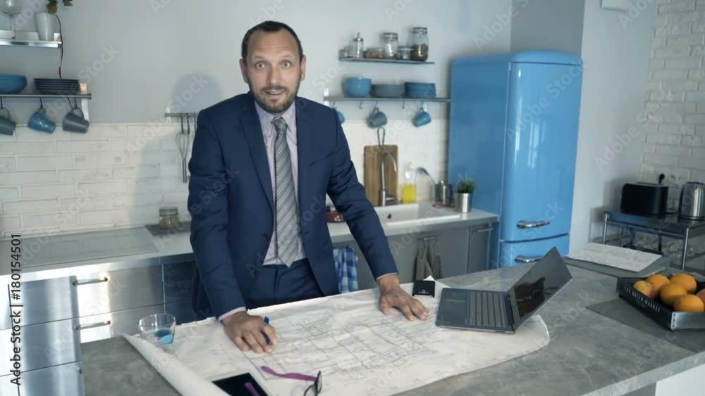Portrait of happy architect with blueprints at home
Portrait of happy architect with blueprints at home