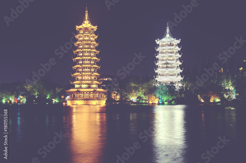 Guilin Sun and Moon Tower Pagodas in Fir Lake at night  color toned picture  China