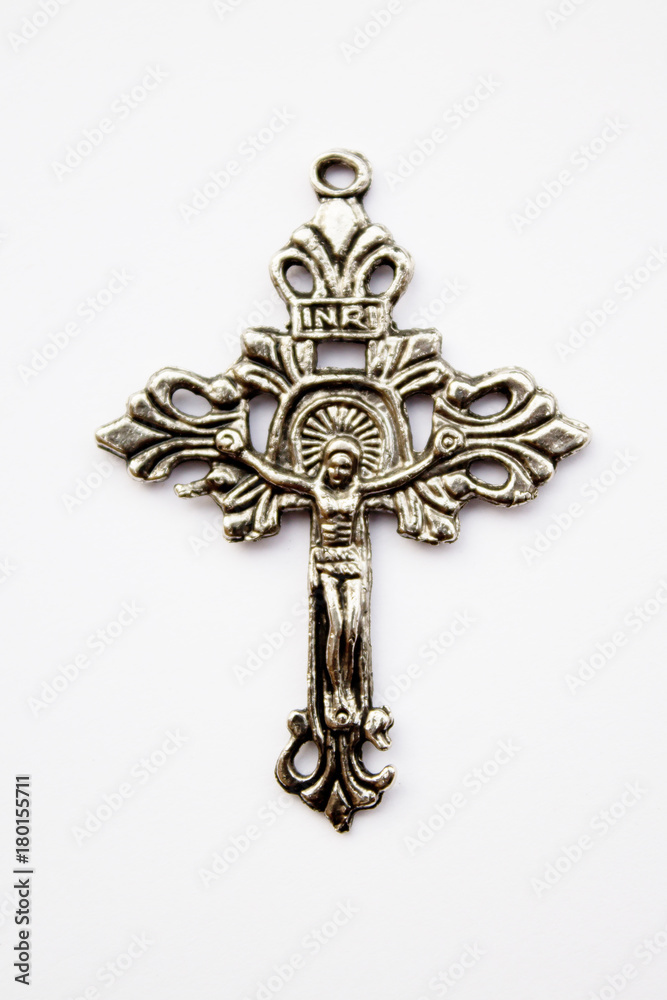 silver cross with a jesus on white background