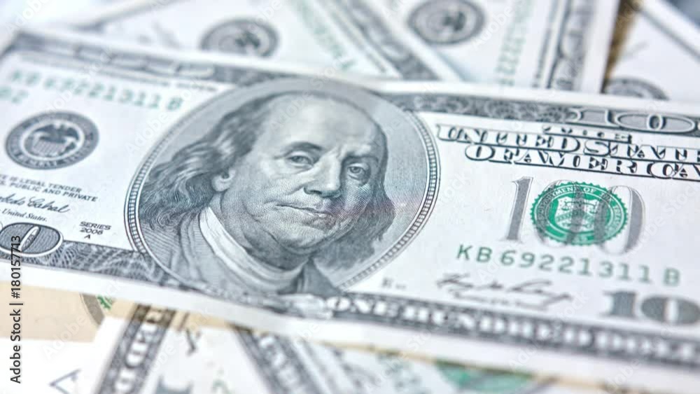 A pile of hundred dollar banknotes on a table. Close-up dolly shot A pile of hundred dollar banknotes on a table. Close-up dolly shot
