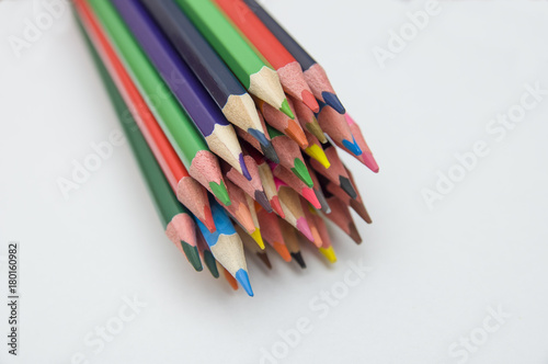 many multicolored pencils on white background