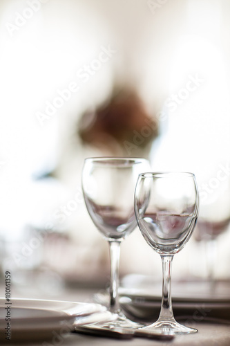 Photo of two wineglasses on blurred background