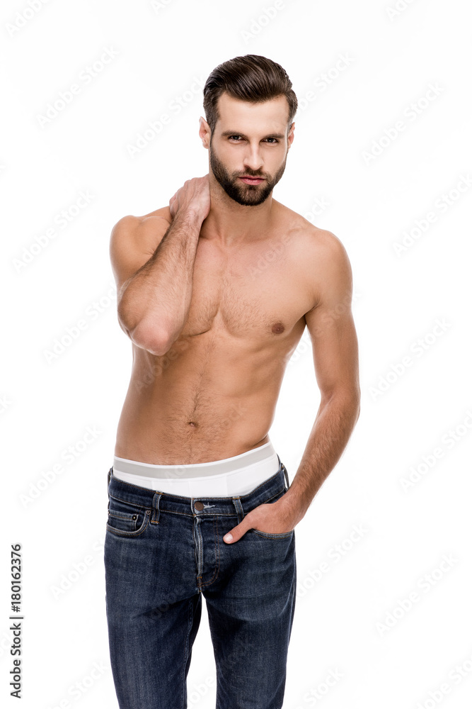 Take a look at this handsome! Handsome shirtless young man in jeans looking at camera while standing against white background Take a look at this handsome! Handsome shirtless young man in jeans looking at camera while standing against white background