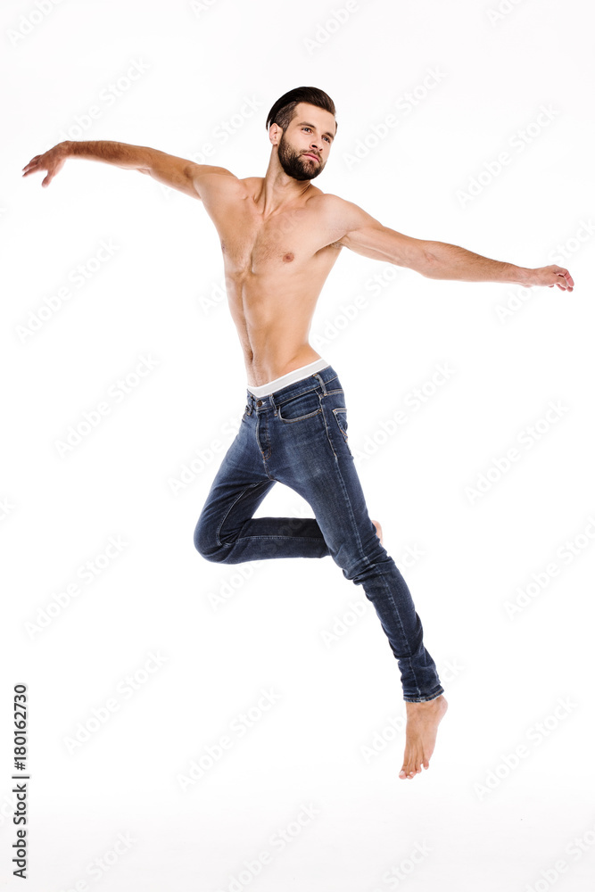Handsome dancer. Full length of handsome young man in jeans looking away while moving against white background. Handsome dancer. Full length of handsome young man in jeans looking away while moving against white background.