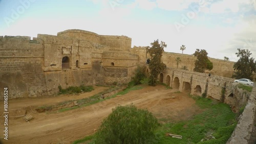 cars drive along the bridge to the ancient city in the old fortress photo