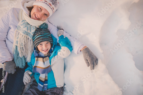 Happy family mother and child sun having fun, playing at winter park