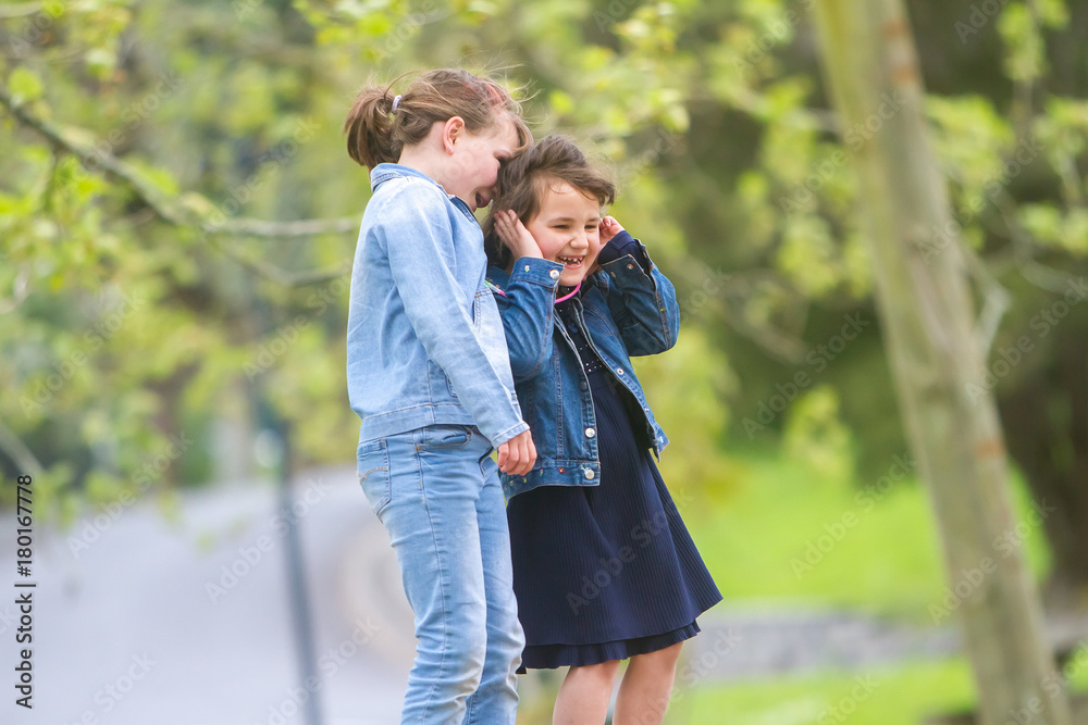 Naklejka premium outdoor portrait of young happy girls having fun on playground