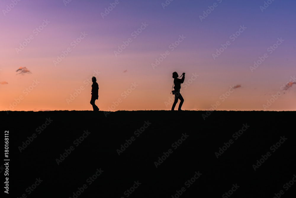 People silhouette on a top of a hill
