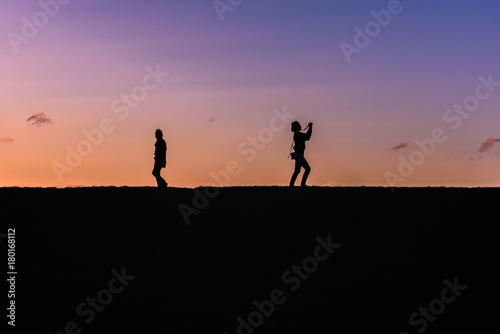 People silhouette on a top of a hill