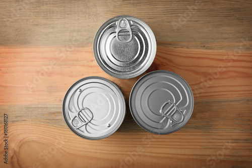 Tin cans on wooden background