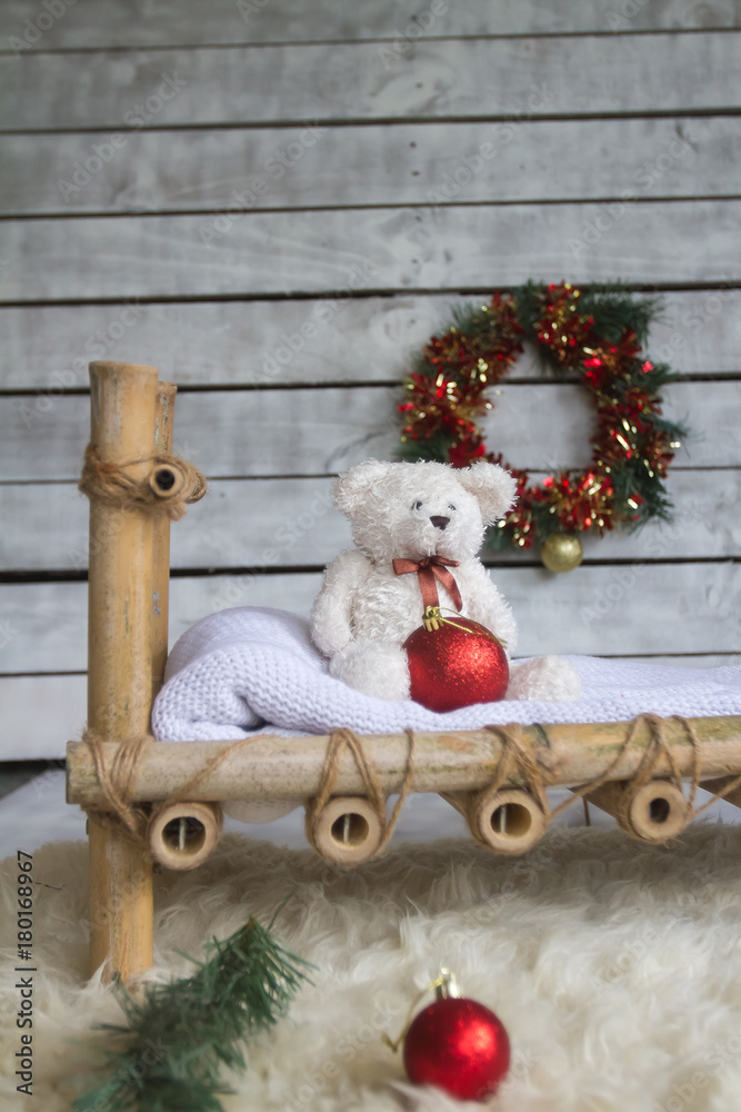 christmas setup, xmas decoration with newborn babmboo bed and toy teddy bear