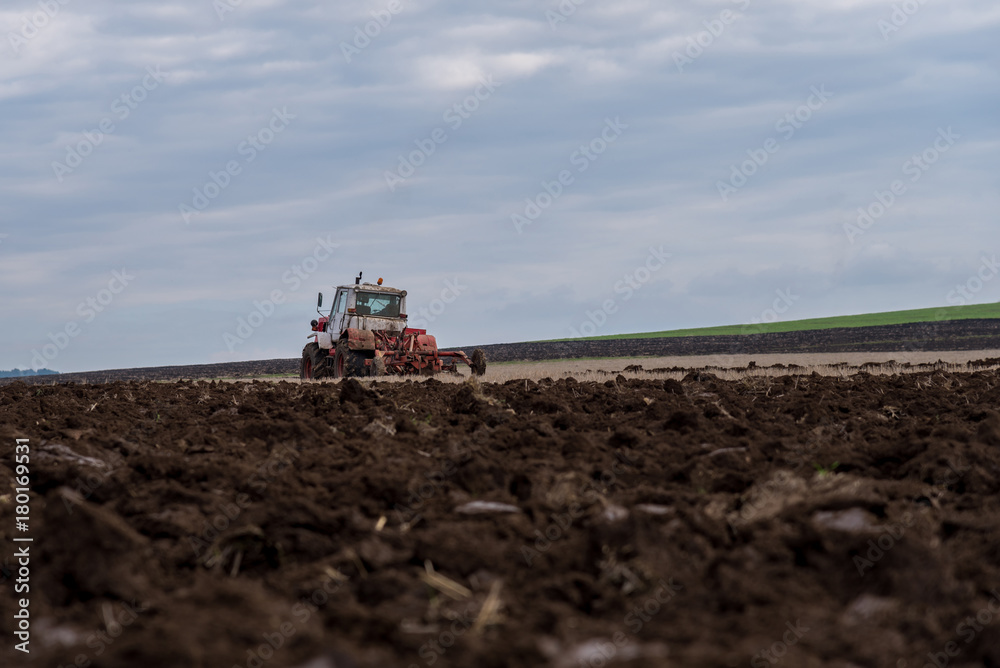 Fototapeta premium Tractor plowing fields.