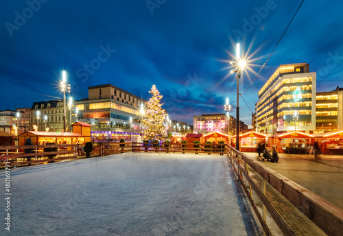 Traditional street market and ice skating rink at Christmas time