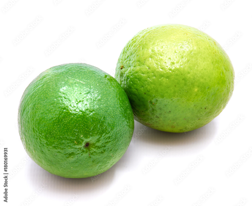 Two whole green limes isolated on white background. Two whole green limes isolated on white background.