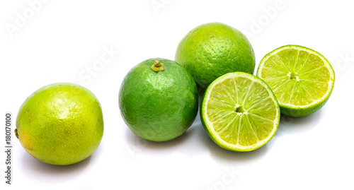 Group of whole and lime halves isolated on white studio background.