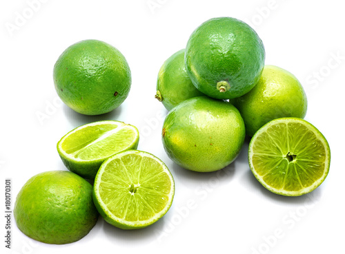 Group of whole and lime halves isolated on white studio background.