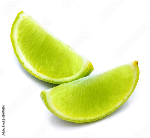 Two lime slices isolated on white studio background.