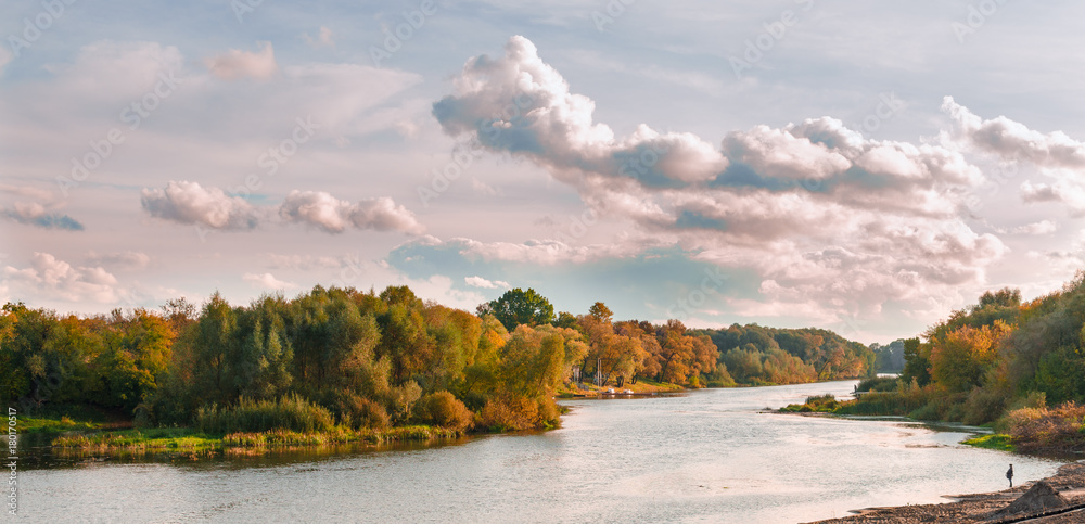 Autumn river in the background of a forest with an expressive sky Autumn river in the background of a forest with an expressive sky